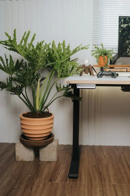 An artist is fully absorbed in sketching on an iPad within a modern studio setting.